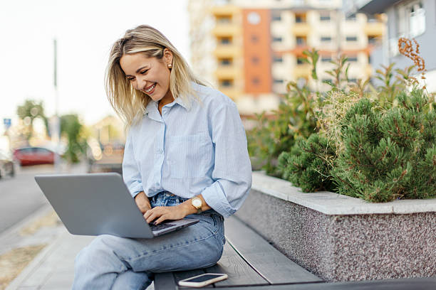 istock Businesswoman working on laptop outside 2224384972