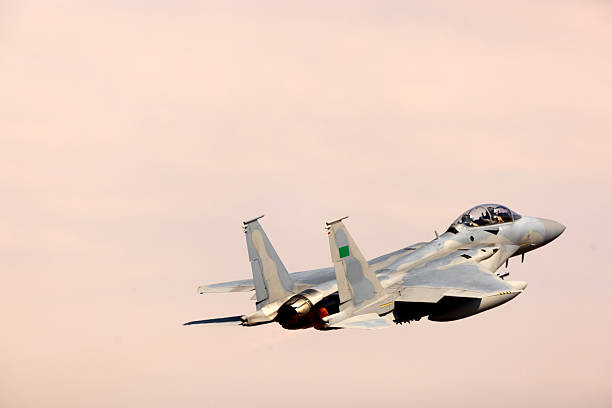 istock F-15 Fighter Jet flying over clouds 2224387343