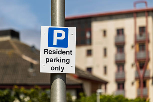 istock Resident Parking Only Sign with Blurred Urban Background 2224387739