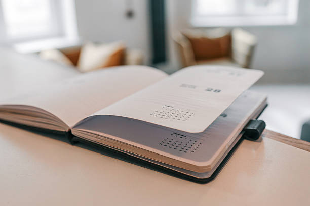 An open schedule planner book and pen.