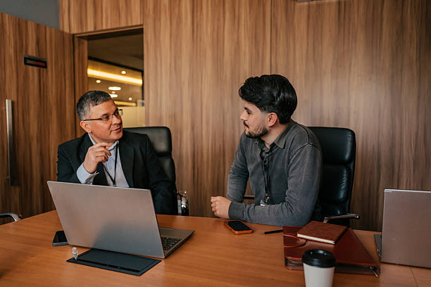 istock Two colleagues talking in the office 2224395942