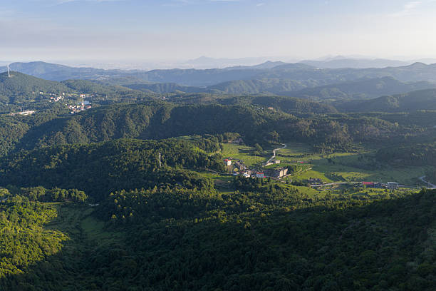 istock Rolling hills and countryside covered with lush greenery 2224397026