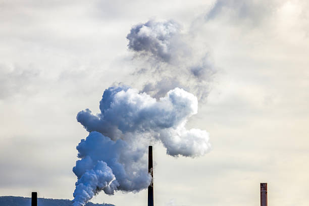 istock Air pollution from factory stack with heavy smoke released into the sky, background with copy space 2224398130
