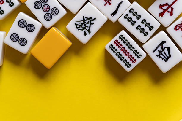 istock Mahjong tiles lined up on a yellow background 2224399094