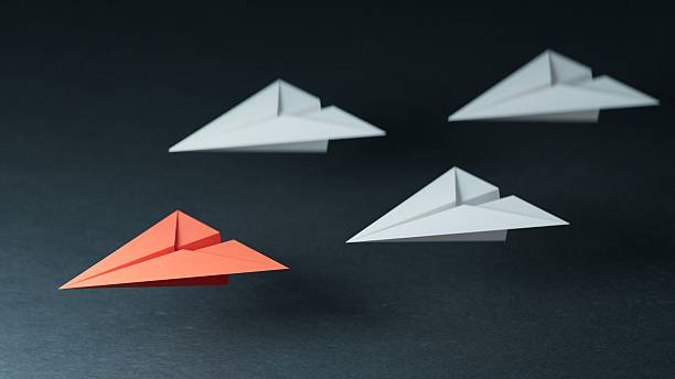 istock Different business concept.new ideas. paper art style. creative idea.Leaderplane concept, red leader plane leading white planes.3D rendering on black background. 2224400269