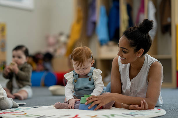 istock Teacher Engaging With Children During Playtime in a Colorful Classroom Environment 2224402221