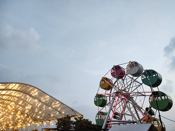 istock A mini Ferris wheel with a sunset sky in the background. 2224406026