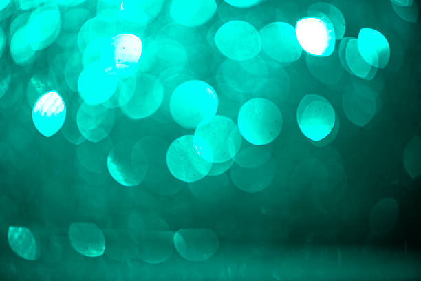 istock A glowing green gradient evokes seasonal wonder. The defocused particles float like falling coins in the celebration air. Capturing the texture of joy for new year's eve and happy birthday themes. 2224406381