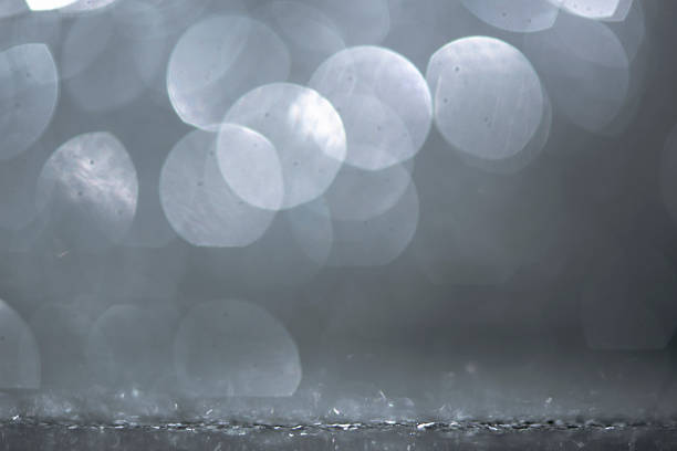 Featuring graceful, abstract, and beautifully defocused soft focus bokeh effects, this image exudes a sophisticated shiny, glowing appearance highlighted by touches of subtle glitter. With refined silver colored and tasteful gray color tones, it radiates quiet elegance and understated luxury, offering considerable copy space as a versatile design element. Suitable for festive celebration backgrounds, romantic occasions like weddings, anniversaries, holidays such as Christmas, New Year's Eve, and Valentine's Day - Holiday, and excellent for sophisticated web banner, elegant wallpaper - decor, decorative slide show projects, and stylish visual design concepts.