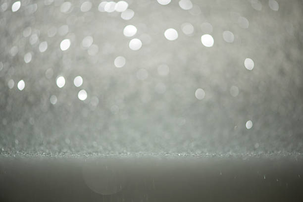 This image features an abstract and beautifully defocused background with delicate soft focus circles creating a dreamy effect. The shiny, glowing surface is enhanced with subtle glitter, displaying an elegant blend of silver colored and refined gray color tones. With an essence of elegance and luxury, this versatile backdrop is an excellent design element, providing ample copy space. Ideal for various festive occasions, it suits celebrations, sophisticated party - social events, memorable weddings, meaningful anniversaries, and seasonal festivities like Christmas, New Year's Eve, and Valentine's Day - Holiday. Its romance and dreamlike atmosphere also fits beautifully into themes related to vacations and decorative presentations. Highly suitable for decoration projects, textured graphic compositions, web promotions (web banner), stylish digital displays (wallpaper - decor), creative design work, engaging slide shows, and visuals focusing on focus on foreground.
