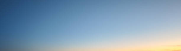 istock Gradient blue golden dusk clear sky dawn plain background banner 2224407701