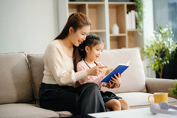 istock A caring mother and young daughter share a bonding moment doing homework at home. 2224407987