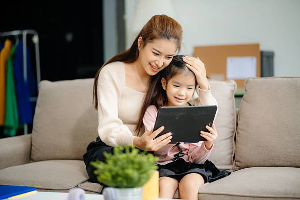 istock A caring mother and young daughter share a bonding moment doing homework at home. 2224408000