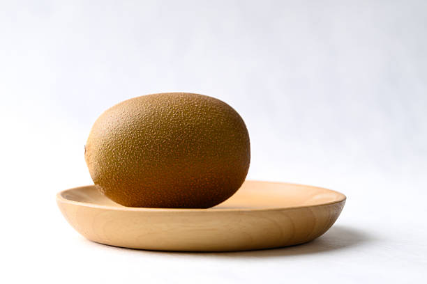 Fresh kiwi fruit with wooden plate on white background, Healthy fruit