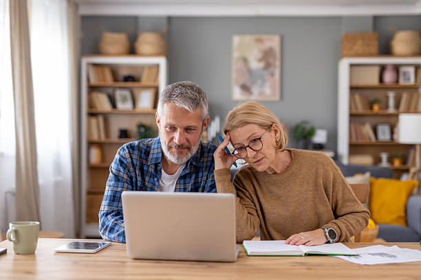 istock Couple Working Together on Laptop at Home Office Table 2224415171