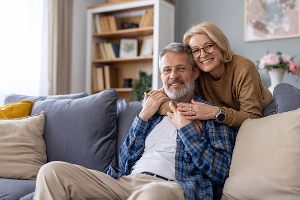 Warm smiles and love shared between a couple on the couch