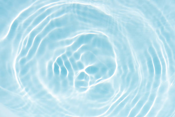 istock Blue water with ripples on the surface. Defocus blurred transparent blue colored clear calm water surface texture with splashes and bubbles. Water waves with shining pattern texture background. 2224418710