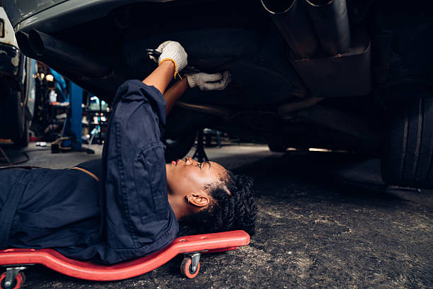 istock Auto mechanic are repair maintenance underneath a car. 2224419676