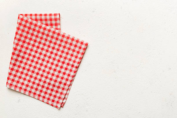 top view with red empty kitchen napkin isolated on table background. Folded cloth for mockup with copy space, Flat lay. Minimal style