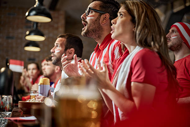 istock Soccer fans watching a game on TV in a pub. 2224422244