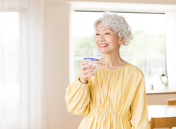 istock Gray-haired Japanese woman drinking water 2224423011