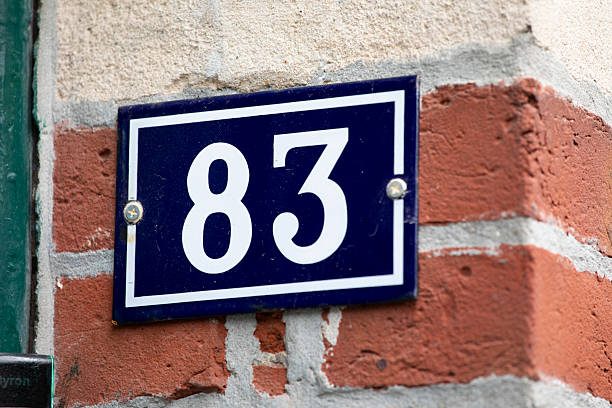 istock House number 83 on a brick wall 2224423373