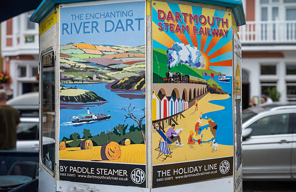 Stylish art posters advertising tourist trips on a steam railway and a paddle steamer in Dartmouth, Devon, UK