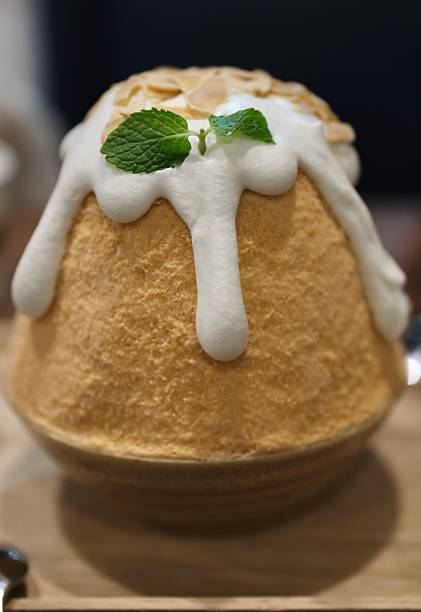 istock Thai tea shaved ice delights, or bingsu Thai tea on wooden table. 2224426869