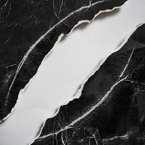istock The Old Black Paper was Evenly Torn on The Diagonal with White Space in Between 2224427479