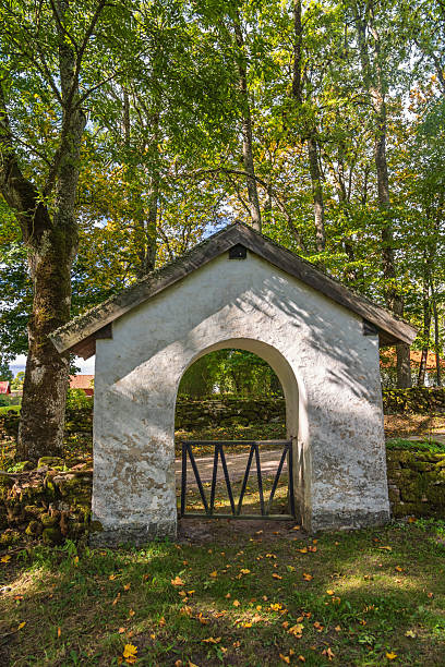 istock Church gate by a road in a forest 2224427508