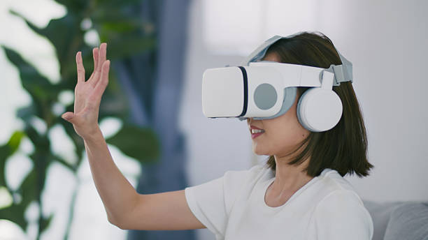 istock Young Asian Woman Experiencing Virtual Reality with VR Headset at Home. 2224430362