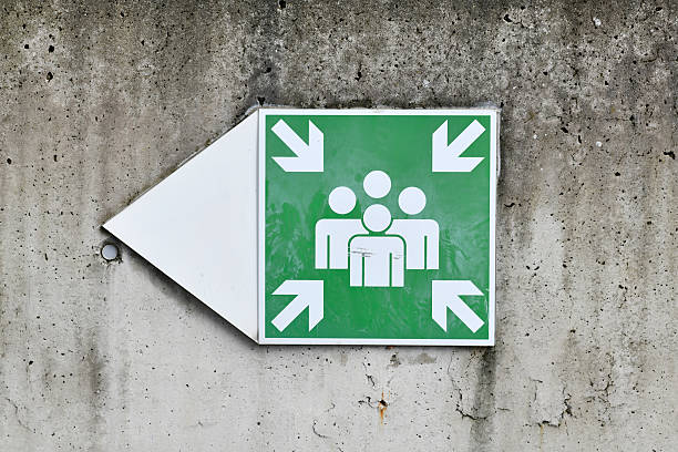 Emergency assembly point sign on concrete wall