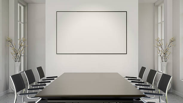istock Blank frame or white board or a screen on wall over a black table and swivel chairs in meeting room. 2224435850