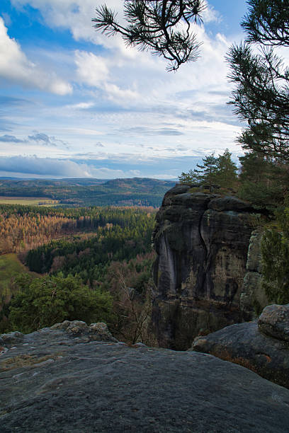 istock Majestic rock formation rises above wooded valley under blue sky 2224437230