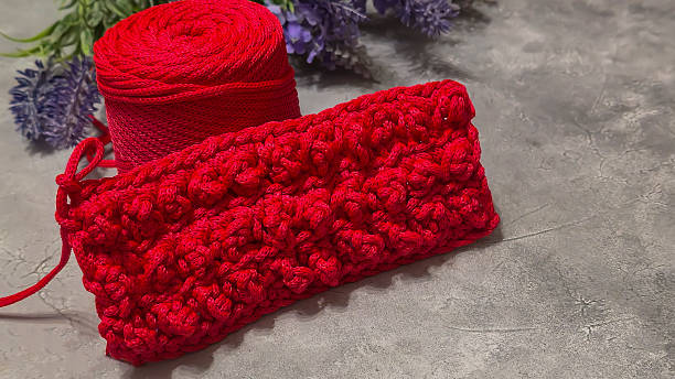 istock Pattern for knitting a bag. Crocheted from polyester cord. On a gray background 2224437606