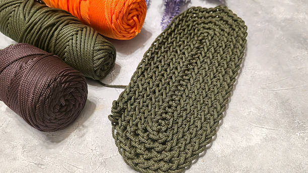 istock Crochet bag bottom made of green polyester cord. On a gray background. design 2224438431