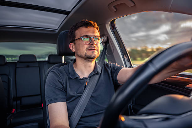 istock Driver in motion. Focused look. Sunset car interior 2224439762