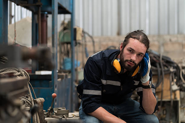 istock Industry factory, male worker, workshop. Male worker tired from working, looking streesed, feeling sice or unwell in place of work at factory 2224443894