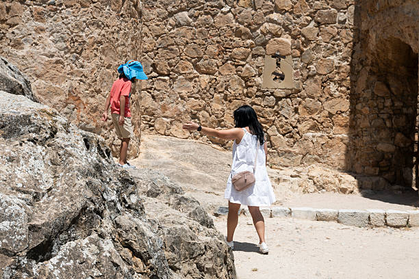 Tourists exploring ancient ruins during summer vacations, promoting family travel and historical sightseeing
