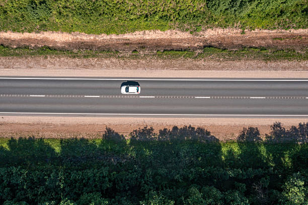 istock Car travels on a highway surrounded by greenery during daylight hours 2224452039