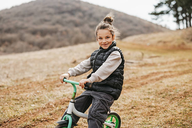 istock Beautiful boy riding bicycle in nature 2224452576
