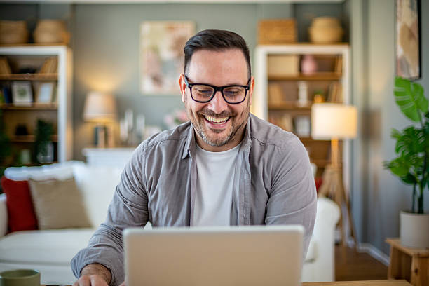 istock Happy freelancer working from home on laptop and smiling 2224453184