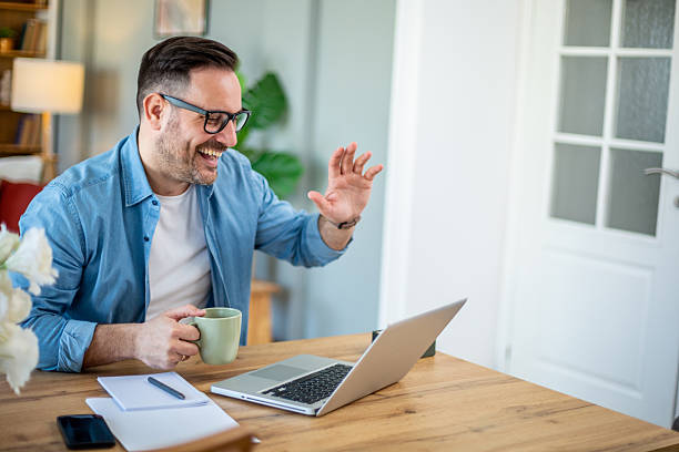 istock Happy entrepreneur waving during video call from home office 2224453495