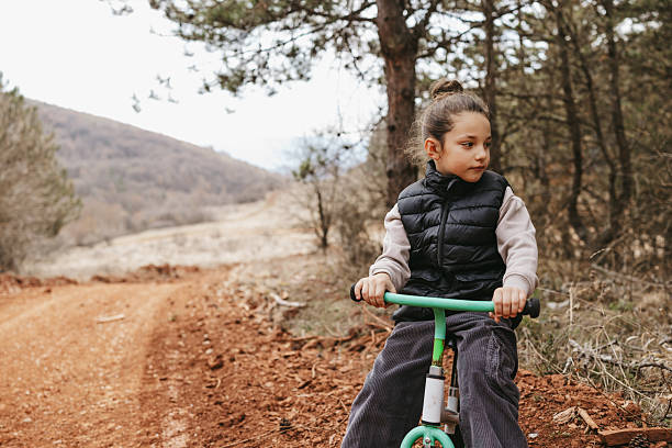 Beautiful boy riding bicycle in nature