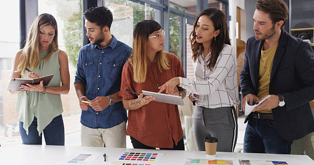 istock Business people, teamwork and tablet with planning, creative project and brainstorming with app. Group, employees and graphic designers in office, cooperation and tech with color for proposal or talk 2224455143