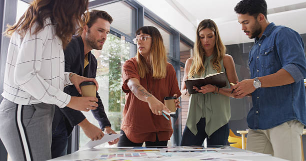 istock Creative, meeting and business people in office for planning, teamwork and ideas for book design. Publishing agency, discussion and workers with notes, color palette and editorial layout for print 2224455175
