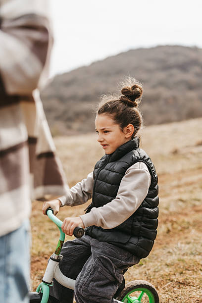 istock Beautiful boy riding bicycle in nature 2224456029