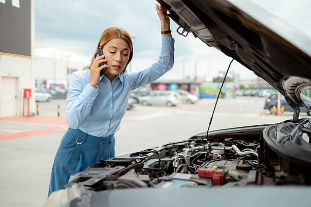 istock Female Driver Using Smartphone to Call for Roadside Assistance – Car Malfunction and Emergency Concept 2224457140
