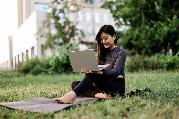 istock Online yoga class at park 2224460585
