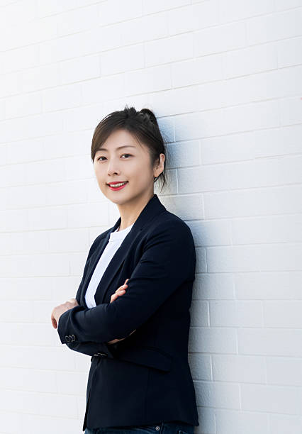 istock Confident woman standing with arms crossed 2224463746